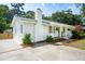 Exterior view of home featuring an inviting entrance, manicured landscaping, brick chimney and concrete driveway at 521 Carpenter St, Charleston, SC 29412