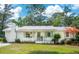 Charming single-story home featuring white brick, a brick chimney, and a lush green lawn at 521 Carpenter St, Charleston, SC 29412
