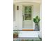 Close-up of the front door featuring a green door with decorative window panes, creating a welcoming entryway at 521 Carpenter St, Charleston, SC 29412