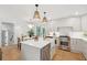 Well-appointed kitchen with stainless steel appliances, an island, and pendant lighting open to the dining area at 521 Carpenter St, Charleston, SC 29412