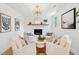 Bright living room featuring a white brick fireplace and modern gold light fixture at 521 Carpenter St, Charleston, SC 29412