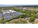Aerial view of colorful townhomes surrounded by lush trees, and water views at 656 Coleman Blvd # 703, Mount Pleasant, SC 29464
