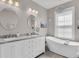 Elegant bathroom featuring double sinks, marble countertops, and a freestanding bathtub for a luxurious experience at 656 Coleman Blvd # 703, Mount Pleasant, SC 29464
