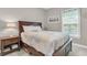Serene bedroom with a wooden bed frame, soft bedding, and a window providing natural light for a peaceful sanctuary at 656 Coleman Blvd # 703, Mount Pleasant, SC 29464