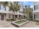 Charming multi-story townhome featuring brick accents, palm trees, and a lovely water fountain at 656 Coleman Blvd # 703, Mount Pleasant, SC 29464