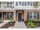 Attractive townhome entrance with a black door, brick accents, and manicured landscaping at 656 Coleman Blvd # 703, Mount Pleasant, SC 29464