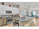 Spacious kitchen featuring a large island, pendant lighting, and a mix of white and neutral-toned cabinetry at 656 Coleman Blvd # 703, Mount Pleasant, SC 29464