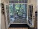 Inviting screened porch with seating offers a tranquil view of the surrounding trees and lush greenery at 656 Coleman Blvd # 703, Mount Pleasant, SC 29464