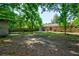 Expansive backyard with a brick home, mature trees, patio, and a storage shed at 7 Azalea Ct, Goose Creek, SC 29445