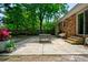 Spacious backyard featuring a brick home, paved patio, lush lawn, patio furniture, and a grill at 7 Azalea Ct, Goose Creek, SC 29445