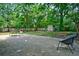 Spacious backyard with a paved patio, modern patio furniture, lush green lawn, and a storage shed at 7 Azalea Ct, Goose Creek, SC 29445
