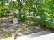 Aerial view of a spacious backyard with a storage shed, mature trees, and a fenced perimeter at 7 Azalea Ct, Goose Creek, SC 29445