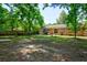 Spacious backyard featuring a patio, brick home, wooden fence and lush green trees at 7 Azalea Ct, Goose Creek, SC 29445