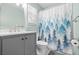Bathroom featuring a stylish gray vanity, modern faucet, forest-themed shower curtain, and bright natural light at 7 Azalea Ct, Goose Creek, SC 29445