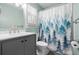 Bathroom featuring a stylish gray vanity, modern faucet, forest-themed shower curtain, and bright natural light at 7 Azalea Ct, Goose Creek, SC 29445