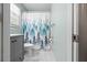 Bathroom featuring a gray vanity, a forest-themed shower curtain, and white marble-look tile flooring at 7 Azalea Ct, Goose Creek, SC 29445