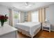 Bright bedroom with wood floors, a ceiling fan, two windows with curtains, and white furniture at 7 Azalea Ct, Goose Creek, SC 29445
