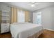 Bright bedroom features wood floors, a ceiling fan, a window, and an ensuite bathroom at 7 Azalea Ct, Goose Creek, SC 29445