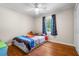 Bedroom with hardwood floors, a ceiling fan, a window, and blue curtains at 7 Azalea Ct, Goose Creek, SC 29445