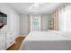Bedroom with hardwood floors, a ceiling fan, a shelving unit, and a large window at 7 Azalea Ct, Goose Creek, SC 29445