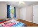 Bedroom with hardwood floors, a ceiling fan, a window with blue curtains, and a closet at 7 Azalea Ct, Goose Creek, SC 29445