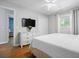 Bedroom with hardwood floors, a ceiling fan, a mounted TV, and a white dresser at 7 Azalea Ct, Goose Creek, SC 29445