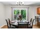 Cozy dining area with a round table, wooden chairs, and sliding glass doors offering outdoor views at 7 Azalea Ct, Goose Creek, SC 29445