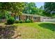 Charming brick home with a well-manicured front yard, green bushes, and a cozy front porch at 7 Azalea Ct, Goose Creek, SC 29445