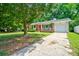 Beautiful brick home with a bright red front door, front porch, green lawn, and driveway at 7 Azalea Ct, Goose Creek, SC 29445