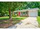 Brick home featuring a front porch and driveway with green lawn and trees at 7 Azalea Ct, Goose Creek, SC 29445