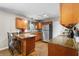 Well-lit kitchen with stainless steel appliances, wooden cabinets, and a granite countertop breakfast bar at 7 Azalea Ct, Goose Creek, SC 29445