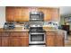 Modern kitchen featuring stainless steel appliances, wooden cabinets, and stylish countertop decor at 7 Azalea Ct, Goose Creek, SC 29445
