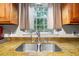 Close-up of a kitchen sink area with stainless steel sink and a window providing natural light at 7 Azalea Ct, Goose Creek, SC 29445