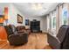 Bright and airy living room with hardwood floors, large TV, and comfortable leather furniture at 7 Azalea Ct, Goose Creek, SC 29445