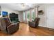 Spacious living room with hardwood floors, ample natural light, and comfortable seating at 7 Azalea Ct, Goose Creek, SC 29445
