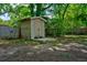 Outdoor storage shed provides extra storage space and is surrounded by lush greenery and mature trees at 7 Azalea Ct, Goose Creek, SC 29445