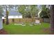 Backyard garden featuring raised garden beds, a wooden fence, and lush green grass at 709 Black Oak Blvd, Summerville, SC 29485