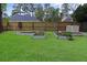 Well-maintained backyard with raised garden beds, lush green grass, and a wooden fence at 709 Black Oak Blvd, Summerville, SC 29485