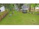 Spacious backyard showcasing green lawn, a tree swing, trampoline, and a wooden fence surrounding the property at 709 Black Oak Blvd, Summerville, SC 29485