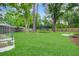 Spacious backyard includes a large lawn, trees, and raised garden beds at 709 Black Oak Blvd, Summerville, SC 29485
