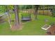 Grassy backyard featuring a trampoline, mature trees, and privacy fence at 709 Black Oak Blvd, Summerville, SC 29485