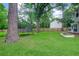 Large grassy backyard with a trampoline and fenced perimeter at 709 Black Oak Blvd, Summerville, SC 29485