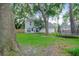Lush backyard with green grass, mature trees, a trampoline, and the house's exterior, creating a serene outdoor space at 709 Black Oak Blvd, Summerville, SC 29485