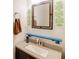 Bathroom features a granite vanity, decorative mirror, and modern sink with plenty of natural light at 709 Black Oak Blvd, Summerville, SC 29485