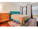 Well-lit bedroom features hardwood floors, a comfortable bed, and a dresser at 709 Black Oak Blvd, Summerville, SC 29485