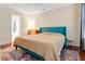 Well-lit bedroom boasts a blue headboard, wood floors, and a stylish rug at 709 Black Oak Blvd, Summerville, SC 29485