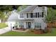 Charming two-story home with symmetrical design, black shutters and a well-manicured lawn and garden at 709 Black Oak Blvd, Summerville, SC 29485