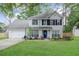 Charming two-story home with symmetrical design, black shutters and a well-manicured lawn at 709 Black Oak Blvd, Summerville, SC 29485