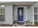 Charming home features a striking blue front door flanked by windows and potted plants at 709 Black Oak Blvd, Summerville, SC 29485
