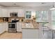 Bright kitchen with granite countertops, stainless appliances, white cabinets, and eat in breakfast bar at 709 Black Oak Blvd, Summerville, SC 29485